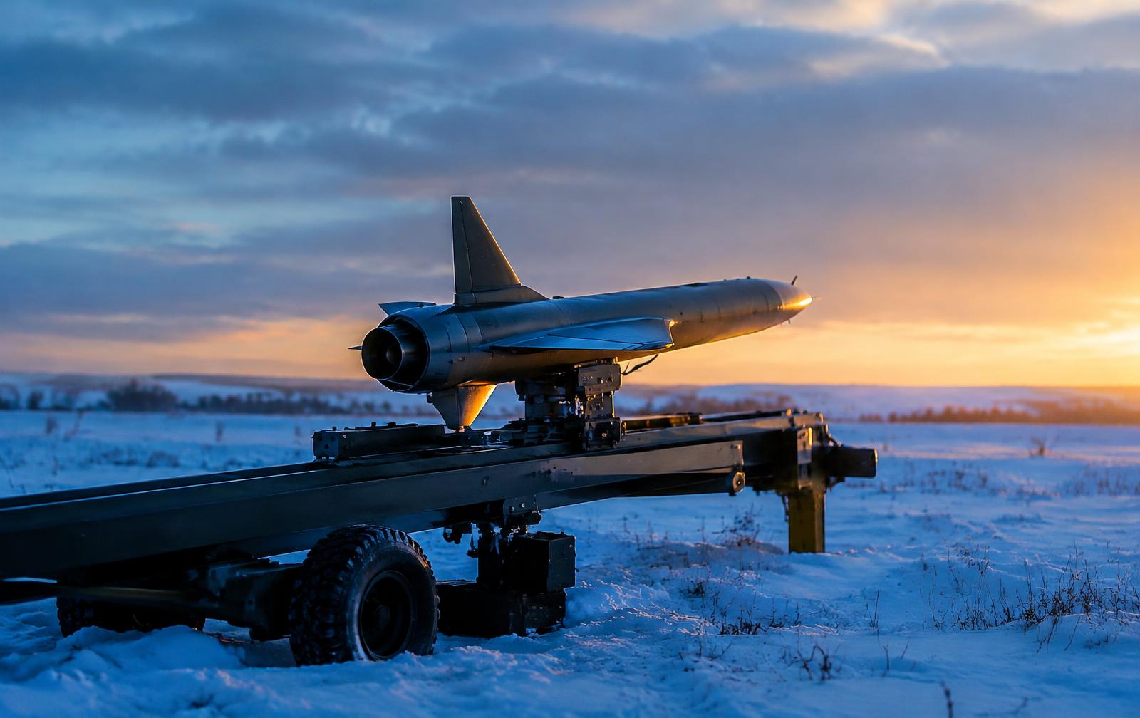 Micro-turbine drone on a rail launcher in a snowy field at sunrise